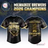 Front and back view of the black baseball jersey with gold graphics and trophy design.