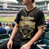 Close-up of a fan wearing the Milwaukee Brewers 2026 World Series Champions Black Baseball Jersey at a stadium.