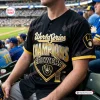 Front view of a black baseball jersey with gold World Series Champions lettering worn in a stadium.