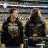 Front and back views of the Milwaukee Brewers 2026 World Series Champions Black Hoodie worn in a stadium.