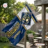Outdoor view of a Milwaukee Brewers 2026 World Series Champions house flag mounted on a wooden porch post.