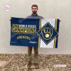 Man holding Milwaukee Brewers 2026 World Series Champions House Flag outdoors.