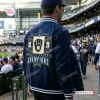Rear view of the Milwaukee Brewers 2026 World Series Champions Varsity Jacket worn at a ballpark.