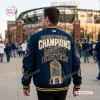 Back view of a person wearing the Milwaukee Brewers 2026 World Series Championship Baseball Jacket at a stadium.