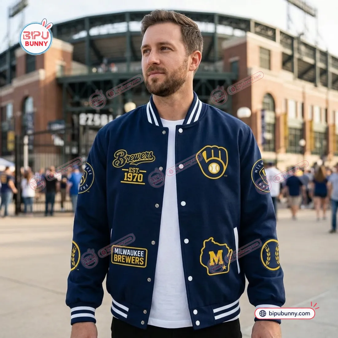 Front view of the Milwaukee Brewers Champions Varsity Jacket worn outside American Family Field showing chest and waist emblems