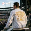 Back view of a person wearing the Milwaukee Brewers Champions White Baseball Jacket 2026 at a stadium.