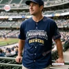 Front view of a fan wearing a Milwaukee Brewers National League Champions navy jersey at a stadium.