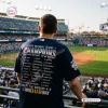 Rear view of a person wearing a navy Milwaukee Brewers National League Champions jersey inside a crowded baseball stadium.