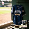 Front view of Milwaukee Brewers National League Champions navy jersey hanging in dugout.