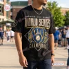 Front view of a black Milwaukee Brewers World Series Champions shirt featuring gold typography and blue baseball graphic.