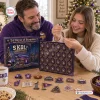 Family opening the Minnesota Vikings Christmas Advent Calendar with ornaments on a table.