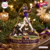 Closeup of a football figurine ornament capturing a memorable touchdown catch on a decorated base.