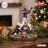 Close-up of Minnesota Vikings Stefon Diggs Miracle Touchdown Ornament on a wooden surface with a Christmas tree background.