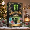 Front view of the Monster Energy All Flavors Advent Calendar 2026 on a festive holiday table with pinecones and lights.