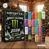 Front view of Monster Energy Drink Advent Calendar 2026 with twenty-four colorful cans arranged next to the holiday box on a wooden table.