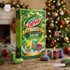 Front view of Mountain Dew All Flavors Advent Calendar 2026 box with soda cans on a wooden table near a lit Christmas tree.