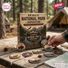 Front view of National Park Adventure Advent Calendar box with collectible wooden badges on a wooden table outdoors.