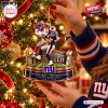 Close-up of a New York Giants Super Bowl XLII Christmas ornament hanging on a lit tree.