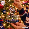 Closeup of hands hanging a New York Giants Super Bowl XLII Christmas ornament on a tree.