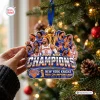 Hand holding New York Knicks 2026 NBA Champions Christmas ornament against a tree.