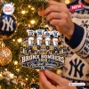 Close-up of a person hanging the New York Yankees Bronx Bombers Ornament 2026 on a lit Christmas tree.