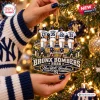 Close-up of hands holding the New York Yankees Bronx Bombers Ornament 2026 hanging on a Christmas tree.