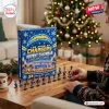 Front view of an NFL Los Angeles Chargers Advent Calendar with mini figures on a wooden table near a decorated tree.
