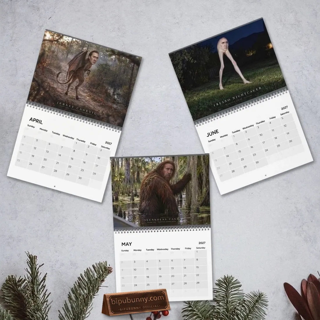 April, May, and June 2027 spreads of the Nicolas Cage Cryptids Wall Calendar featuring Jersey Cagevil, Skunkolas Cage, and Fresno Nightcager