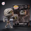 Front view of the Nightmare Before Christmas Mummy Boy vinyl figure standing beside its packaging box.