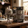Front view of the Nightmare Before Christmas Mummy Boy vinyl figure standing next to its retail box.