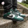 On-feet view of green and silver Nike Dr Doom Custom Dunk sneakers with metal studs on outdoor stone stairs.