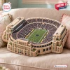 Overhead view of a Notre Dame Fighting Irish plush stadium pillow resting on a beige sofa.