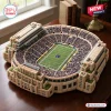 Angled view of a Notre Dame Fighting Irish stadium plush pillow resting on a wooden surface.