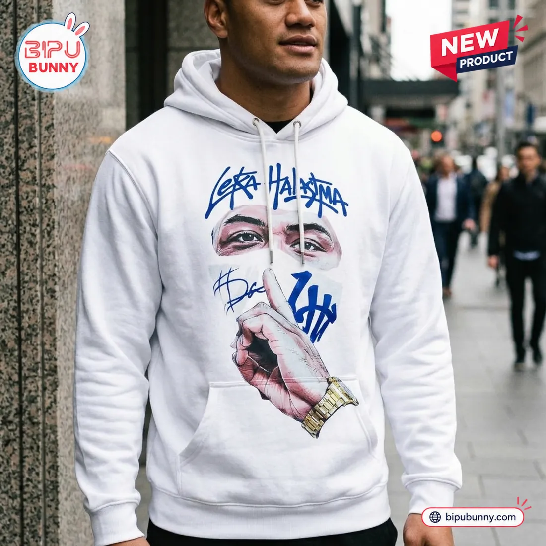 Close-up street view of the NZ Warriors Leka Halasima Limited Edition Hoodie showing the drawstring hood, autograph details, and gold watch graphic