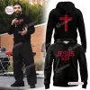 Man wearing Ohio State Buckeyes Jesus Won black hoodie holding a microphone outdoors.