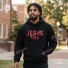 Man wearing an Ohio State Buckeyes Jesus Won black hoodie on a campus sidewalk.