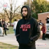 Lifestyle view of a man wearing the Ohio State Buckeyes Jesus Won Black Hoodie outdoors.