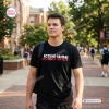 Man wearing an Ohio State Buckeyes Jesus Won black shirt on a college campus sidewalk.