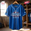 Front view of the Oklahoma City Comets blue baseball jersey featuring Triple-A Champions text graphic.