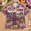 Front view of an Omega Psi Phi purple Hawaiian shirt featuring a graphic print of a seated man, bulldog, and city skyline.