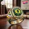Closeup of the Oregon Ducks 132nd Anniversary 1894-2026 Ring with a green gemstone, yellow letter O, and duck mascot.