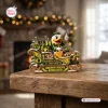 Front view of Oregon Ducks 132nd Anniversary Sleigh Ornament sitting on a wooden surface with a holiday light background.