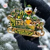 Closeup of the Oregon Ducks 132nd Anniversary Sleigh Ornament held in hands against a snowy tree backdrop.