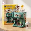 Front view of the Panasy Peanuts Coffee Maker Building Block Set next to its yellow retail box and white character figure.