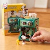 Front view of Panasy Peanuts Coffee Maker Building Block Set featuring a green coffee machine, miniature figures, and yellow box.