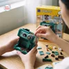 Close-up of hands assembling the Panasy Peanuts Coffee Maker Building Block Set.