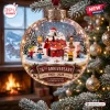 Close-up of the Peanuts 76th Anniversary Glass Christmas Ornament hanging on a tree.