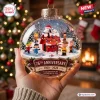 Close-up of a Peanuts 76th Anniversary Glass Christmas Ornament held in a hand.