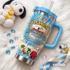 Front view of Peanuts 77th Anniversary YETI handle tumbler featuring blue tie-dye design with Snoopy characters.