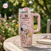 Front view of a pink Peanuts Flora 40oz Tumbler Cup featuring floral patterns and cartoon dog illustrations.